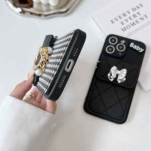 Detail of iPhone wallet cases with houndstooth fabric, pearls and bow accents