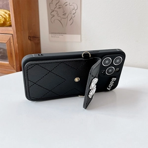 Detail of black diamond-quilted leather wallet case for iPhone with gold snap button
