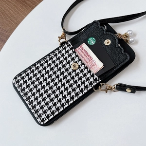 Detail of houndstooth leather phone wallet case with gold snap and pearl charms