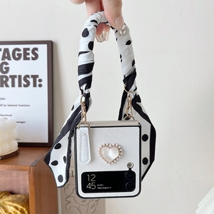 Detail of white litchi leather Z Flip case with heart pearl and polka dot ribbon handle