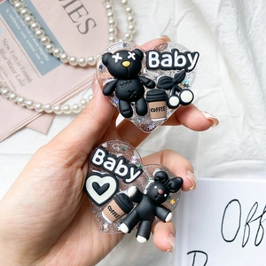 Macro shot of glitter resin heart phone sockets with 3D black bear and rabbit designs