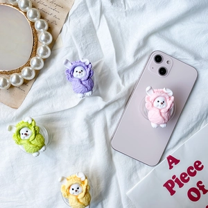 3D cartoon animal phone grip sockets in pastel colors on a soft fabric background