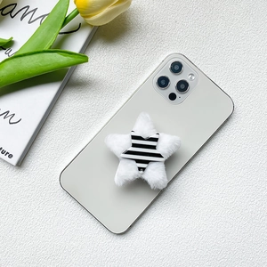 Plush star shape retractable cell phone socket mount on a silver smartphone back