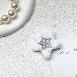 Detail of white plush star phone grip featuring sparkling glitter and soft faux fur texture