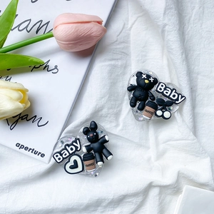Macro shot of heart-shaped glitter phone grips with 3D black bears and Baby letters