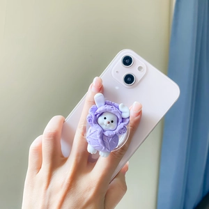 Detailed view of cute rabbit cabbage phone socket holder on pink smartphone for secure grip