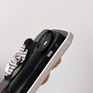 Detail of luxury houndstooth bow phone case with leather strap and precise cutouts
