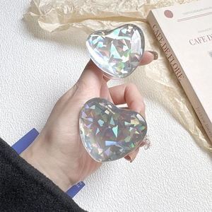 Holographic heart-shaped phone grip with glitter finish and foldable transparent socket
