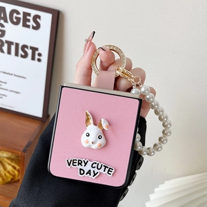Pink Galaxy Z Flip case with pearl strap and cute white bunny figure detail