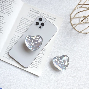 Holographic heart phone grip stand on grey phone with stylish editorial background