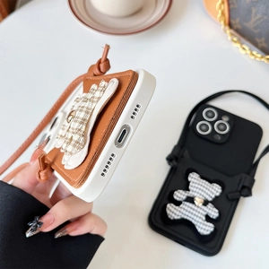 Detail of iPhone case with check bear card holder and matching crossbody strap