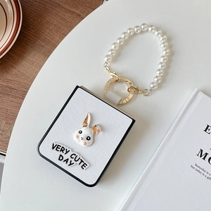 Detail of Galaxy Z Flip 6 white leather case with 3D bunny and pearl handle strap
