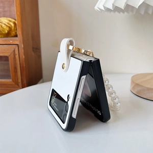 Detail view of white leather Samsung Galaxy Z Flip case with a pearl hand chain strap