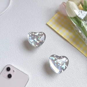 Detail of a laser heart phone socket with a gem-cut iridescent finish on white leather