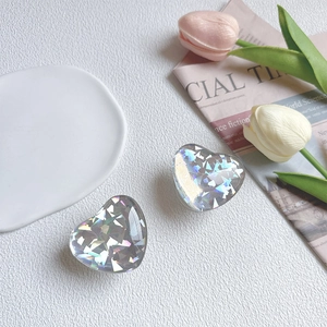 Detail of heart-shaped iridescent laser phone grip with sparkling diamond texture on a tulip background