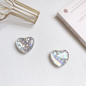 Detail of two laser iridescent heart-shaped phone grips with colorful sparkling glitter