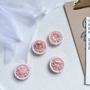 Detailed view of four pink 3D resin cartoon bear and rabbit phone case charms with pearls