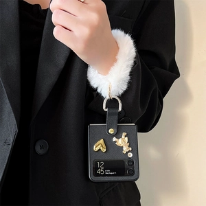 Samsung Z Flip 4 case with black leather texture, gold bear charms, and plush hand strap