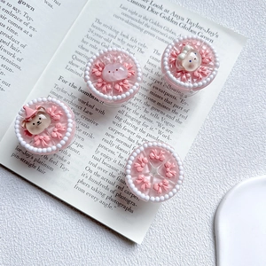Detail of cute 3D pink resin bear and rabbit ornaments with bows and white pearl beads