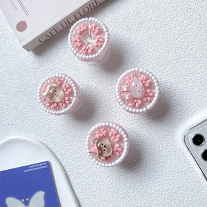 Detail of pink resin cake phone grips with 3D bows, cute bears and rabbits pearls