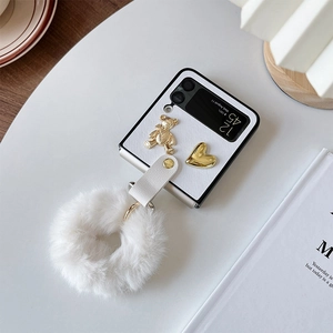 Elegant white Samsung Galaxy Z Flip case with metal bear charm and plush handle chain
