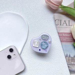 Detail of purple heart phone grip with colorful stones, pearls and LOVE engraving