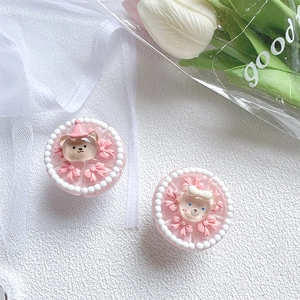 Detail of pink resin cake phone sockets with cute 3D bear, bowknot and pearl border