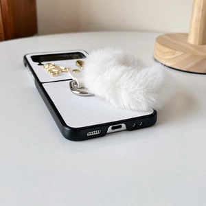 Detail view of Galaxy Z Flip case with plush handle and gold bear ornament