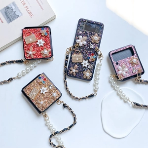 Glittering Samsung Galaxy Z Flip 6 cases with floral pearls, rhinestones, and metal straps