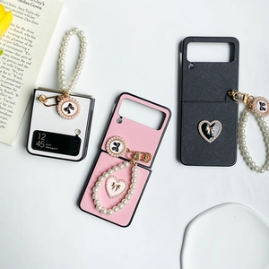 Detail of Z Flip phone case with pearl handle, bow charm, and premium leather texture