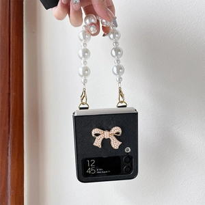 Samsung Z Flip case with pearl bow and pearl handle strap on black cross grain leather