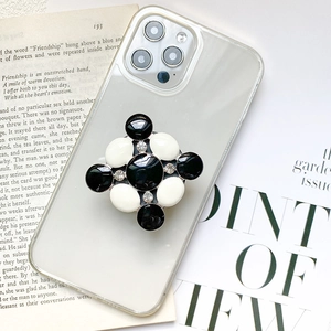 Transparent phone case with stylish black and white floral gemstone pop holder