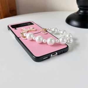 Pink leather phone case for Samsung Z Flip with pearl handle chain and golden bow detail