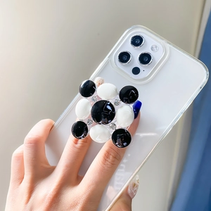 Detail of checkered enamel phone grip with crystals on transparent folding base
