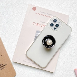 Luxurious metal flower pearl pop socket phone stand on a clear protective case