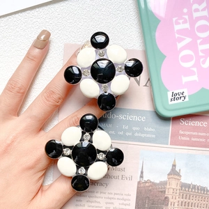 Close-up of black and white checkered flower phone socket with sparkling crystal center
