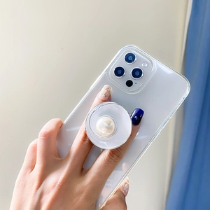 Detail showing hand holding phone with luxury metallic pearl pop-up socket grip