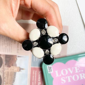 Detail of cross-shaped black and white checkered phone socket with crystal accents