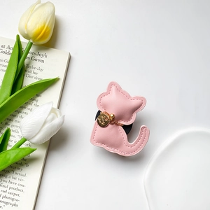Pink cat-shaped leather phone grip with a gold Lucky Girl charm and chain detail