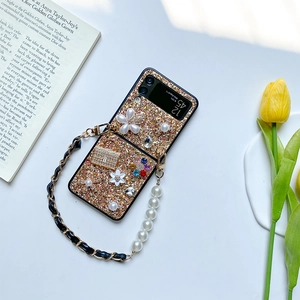 Detail of luxury gold rhinestone phone case with pearl flowers for Samsung Z Flip6