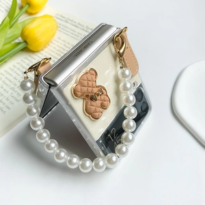 Detail of Galaxy Z Flip case with cream bear ornament and white faux pearl handle strap