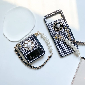 Detail of houndstooth Z Flip case with pearl strap and 3D camellia flower design