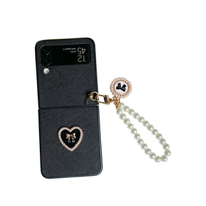 Elegant black leather Galaxy Z Flip case with pearl heart bow and pearl hand strap