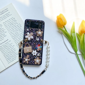 Detail of luxury Z Flip 6 case with purple glitter, floral charms and pearl chain