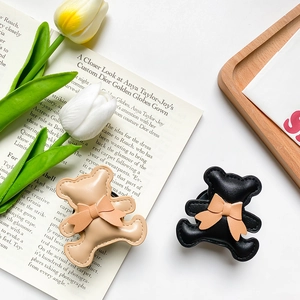 Cute cartoon bear phone grip holder with bow tie and leather stitching in cream and black