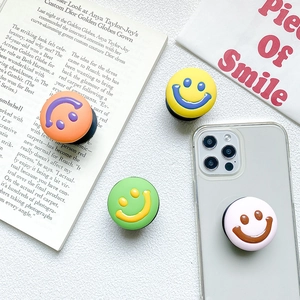 Collage of colorful smile phone grip sockets in orange, yellow, green and pink hues
