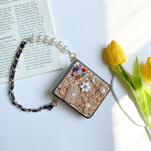 Foldable phone case with gold sequins, floral rhinestones and pearl hand chain