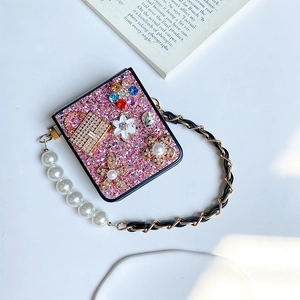 Detail of pink glitter phone case for Samsung Z Flip6 with pearl flower and rhinestone chain