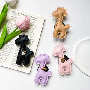 Collage of four deer-shaped PU leather phone sockets with stitching and gold chain details