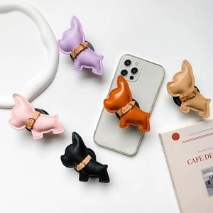 Foldable leather animal grip tok phone stands in five colors on a minimal desk